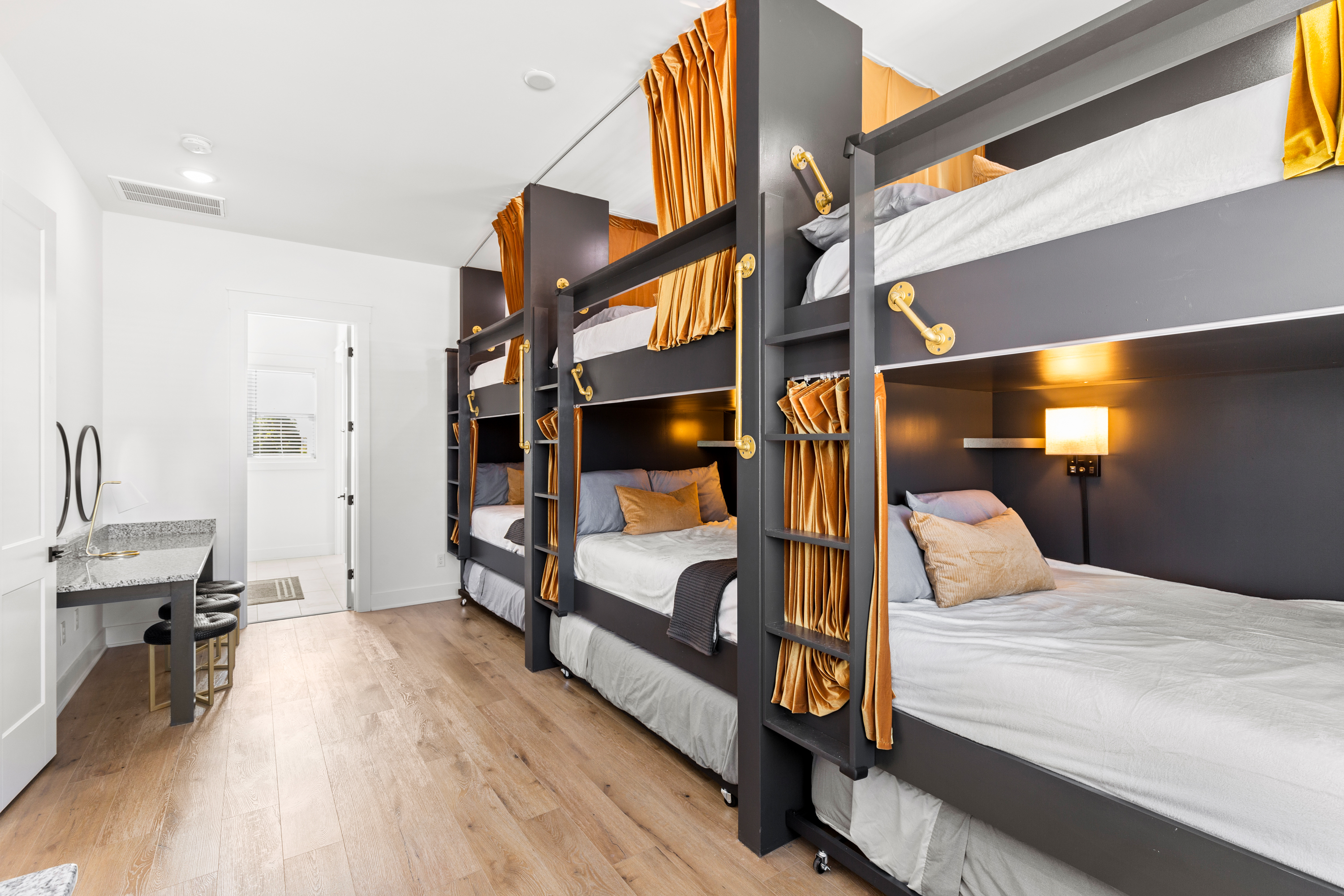 Spacious bunk bed setup with modern lighting and wooden flooring